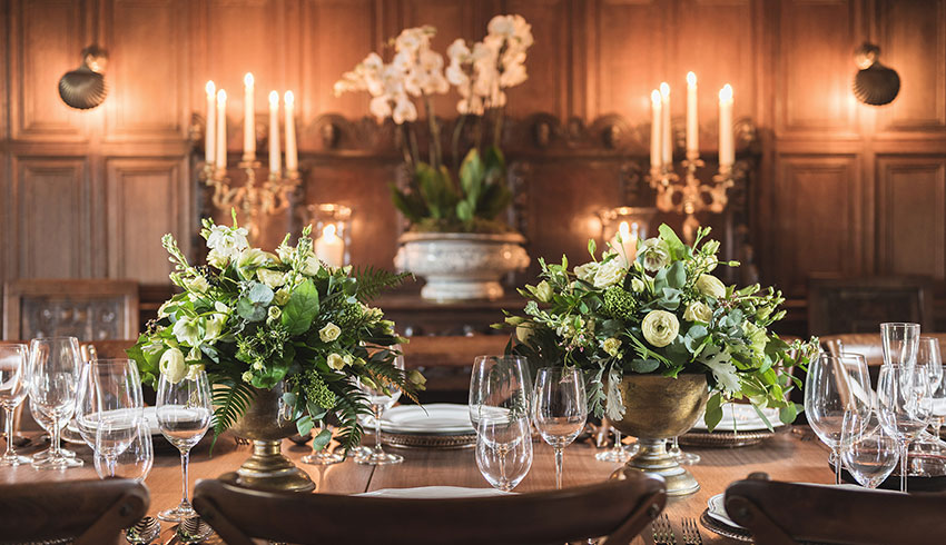 The oak-panelled dining room set up for a wedding breakfast