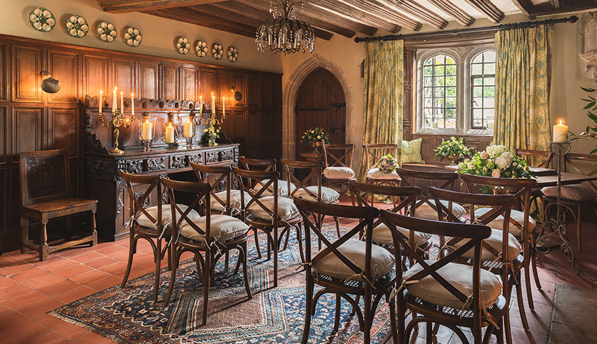 The oak-panelled dining room set up for a wedding ceremony