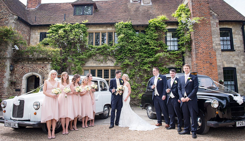 A wedding party arriving outside Broyle Place, a Sussex wedding venue