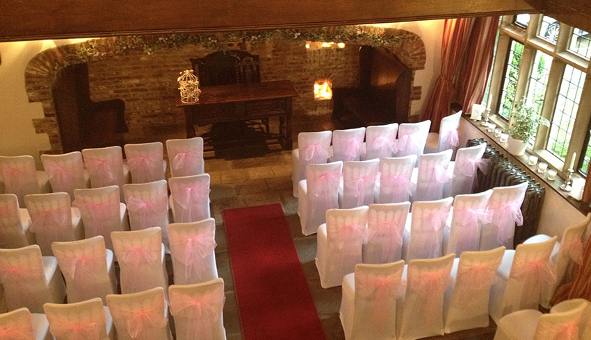 The Great Hall at Broyle Place set up for a wedding ceremony
