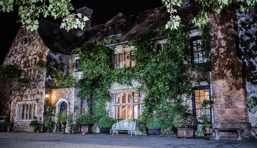 Outside Broyle Place at night, a wedding venue in Sussex