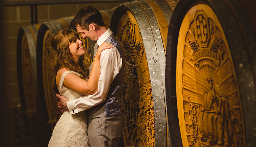 A wedding couple in the wine vaults at Denbies Wine Estate