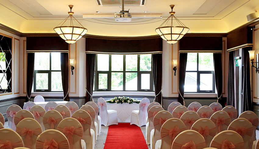 The Hogs Back Hotel, Surrey, showcases a grand wedding ceremony room