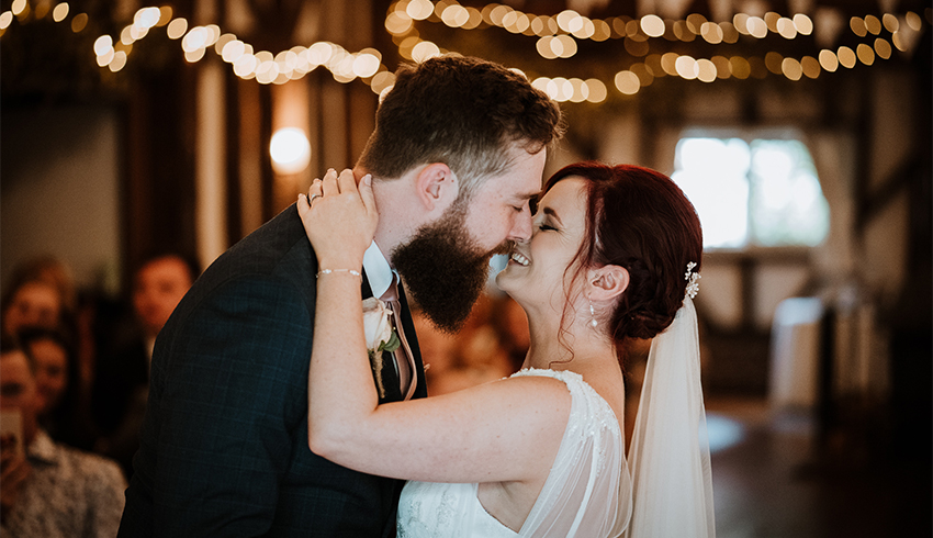 A wedding couple kissing after their ceremony, image by Nicola Dawson Photography