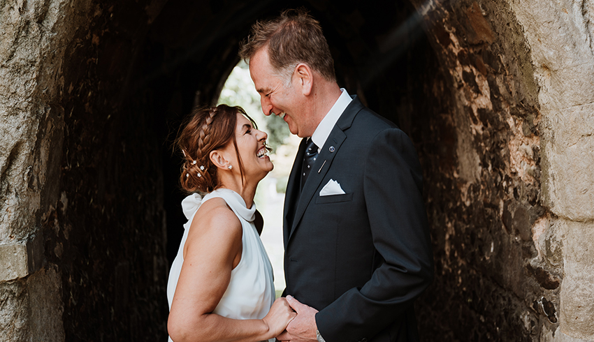 Happy wedding couple taking a moment, image by Nicola Dawson Photography