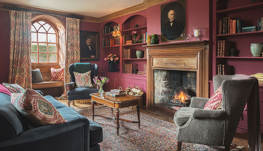 The Library in Battel Hall with its open fireplace and rich coloured interior