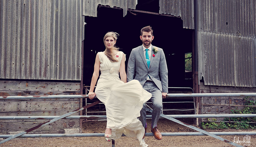 Wedding couple outside farm outbuilding at Northease Manor, a Sussex wedding barn