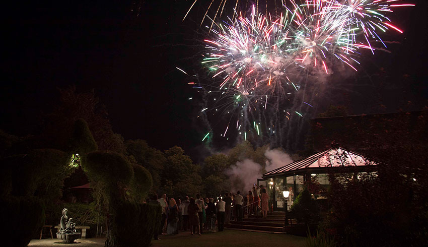 Fireworks at evening wedding reception in the grounds of the Old Mill, Berkshire wedding venue 