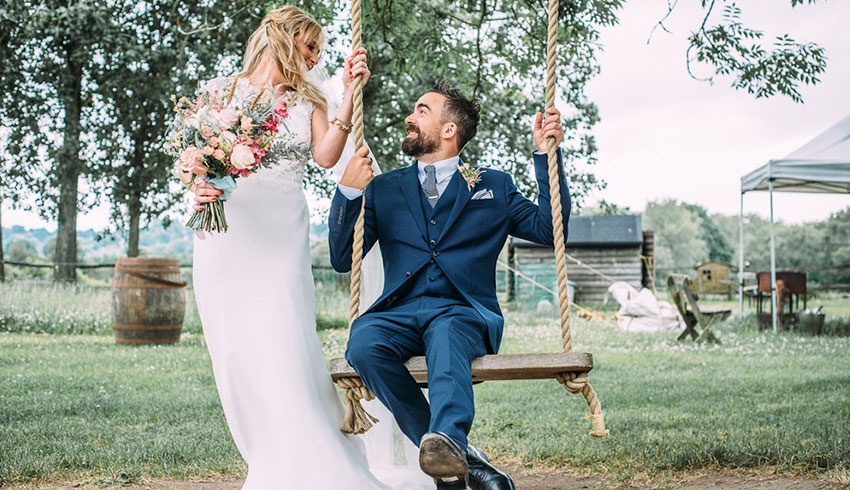 Wedding couple on the swing in the grounds of the Yoghurt Rooms